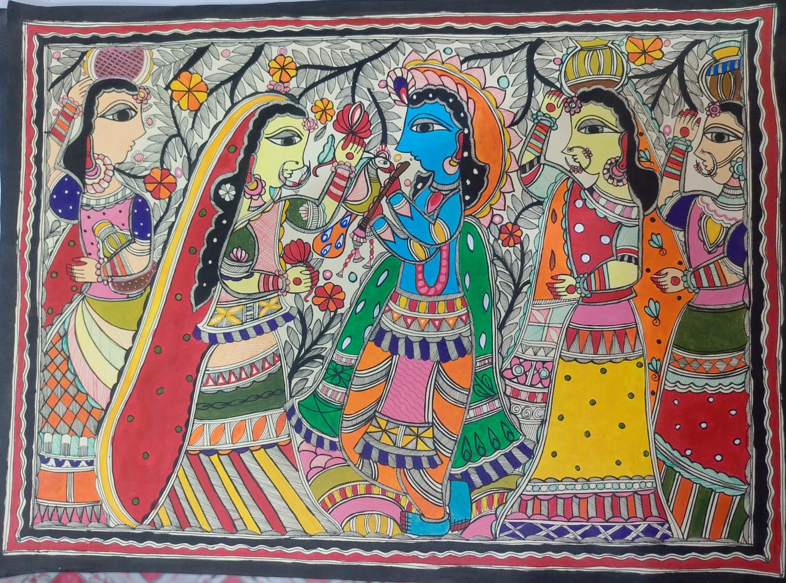 Krishna playing the flute surrounded by gopis